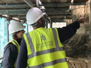 Our-Apprentice,-Emma-Sheridan-being-instructed-by-Gordon-Utting,-Senior-Mason-on-restoration-techniques-at-Royal-Pavillion,-Brighton